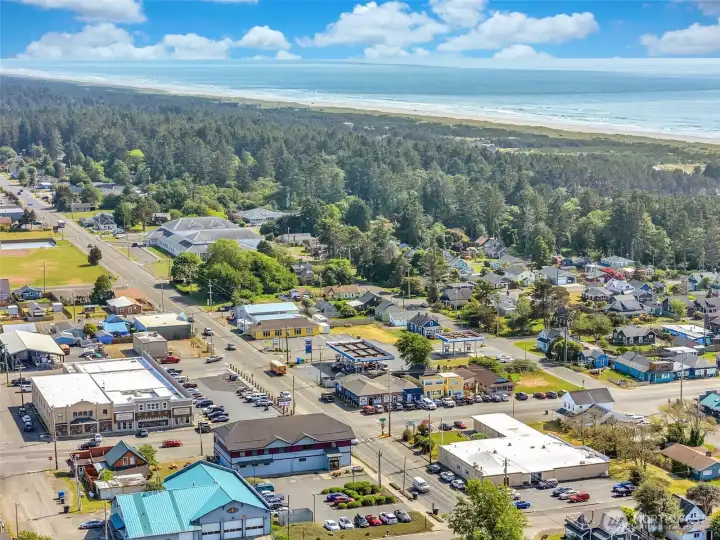 Aerial view toward the coastline, showcasing Ocean Park's unique blend of beach-town living and local commerce.