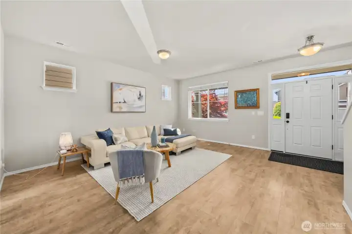 Durable, low-maintenance flooring enhances the inviting entryway and living room