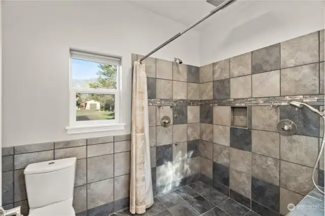 Tiled walk-in shower, bidet toilet in primary bathroom