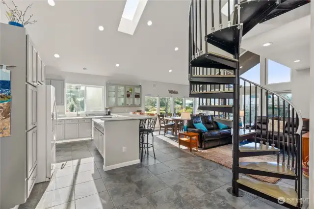 Front entrance into open floorplan kitchen and great room- heated tile flooring throughout main level