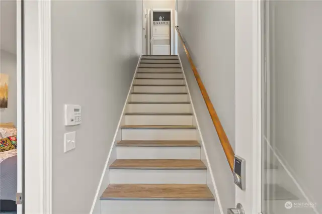 Separate staircase entrance to 2nd level apartment- can also access main house at top of stairs on the left. Laundry machines in that closet at the top of stairs