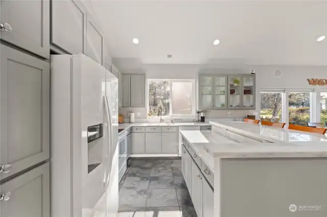 Kitchen with quartz slab countertops and beautiful cabinets, lots of natural light