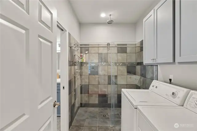 Main level walk-in tile shower with laundry