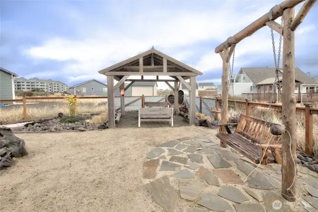 Firepit gathering area and Handcrafted Swing.