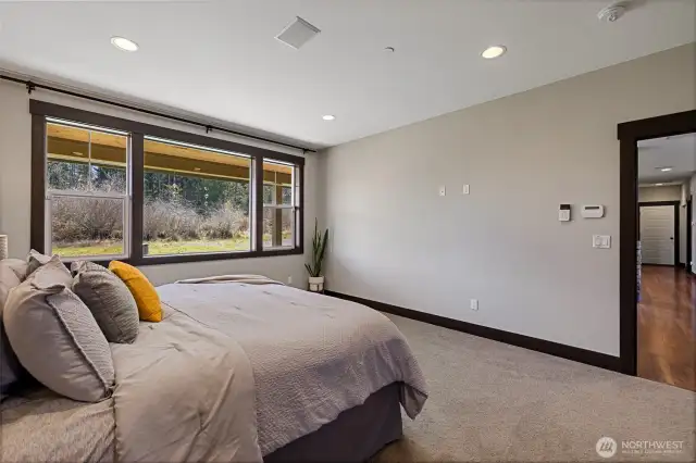 Large windows in the primary suite let in soft natural light.