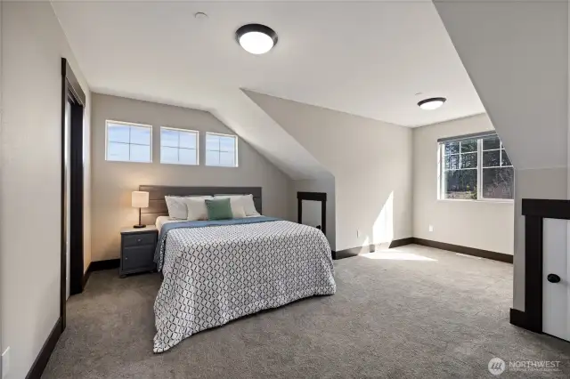 Bedroom located to the right of the stairs—large, bright, and comfortable