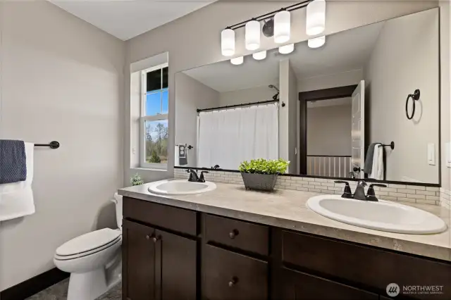 Full bathroom upstairs features double sinks and a bathtub for convenience.