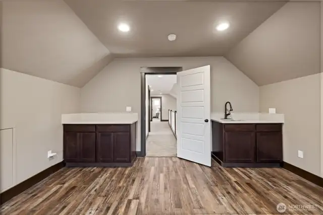 A wet bar and counter on the opposite wall of the theatre room complete the entertainment zone.
