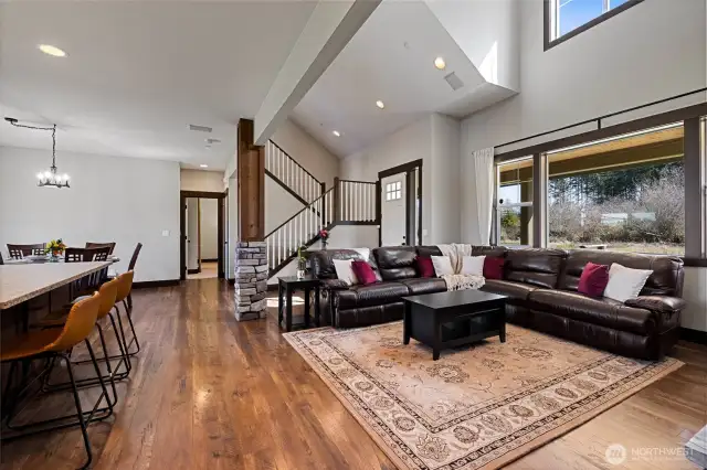Step into a huge living room with vaulted ceilings and an abundance of natural light.
