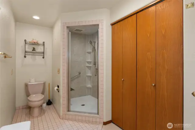 Primary shower with ample storage to the right.