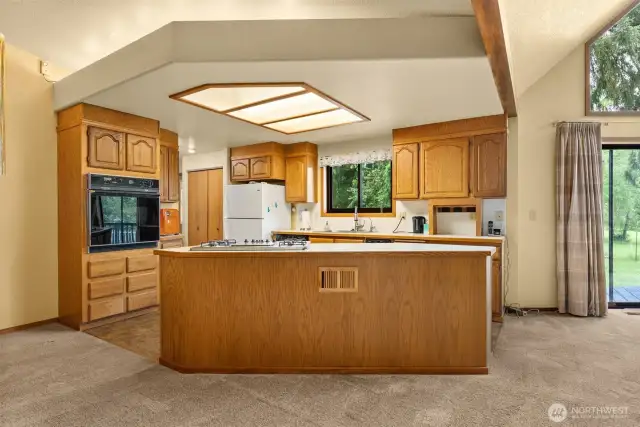 The hallway left of the kitchen to the office and utility room is flanked on both sides with large pantry/storage closets.