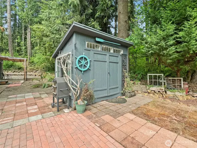 LOG SHED WITH PICNIC TABLE INSIDE