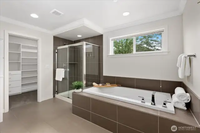 Sleek tile compliments this bathroom with walk in closet