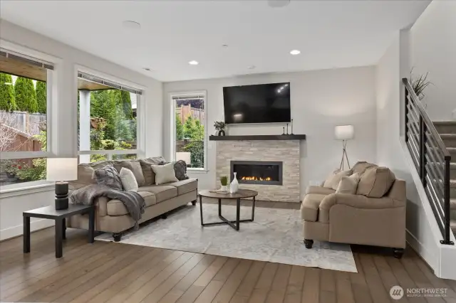 Enjoy cozy evenings by the gas fireplace with large picture windows allowing lots of natural light