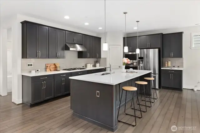 Enjoy the spacious island with seating, sleek cabinetry and quartz countertops