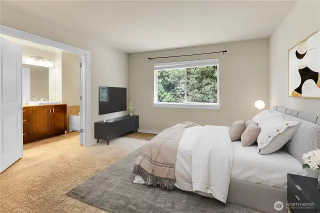 Double doors lead into the spacious primary suite which has an oversized window overlooking the private, fully fenced backyard.  The view of the wooded area in the back of the house, is exceptionally pretty from the primary suite. A walk-in closet is located off the primary bath.