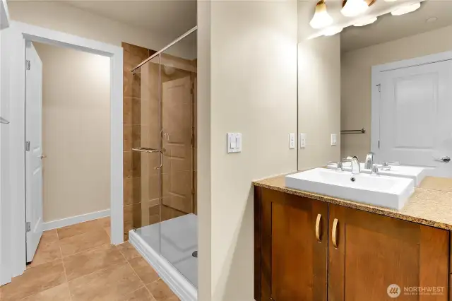 In the primary bathroom there is an oversized glass enclosed shower that is surrounded by tile, and the soaking tub has never even been used.  A window overlooking the backyard fills this bathroom with natural light. The toilet is located in a separate room for privacy.