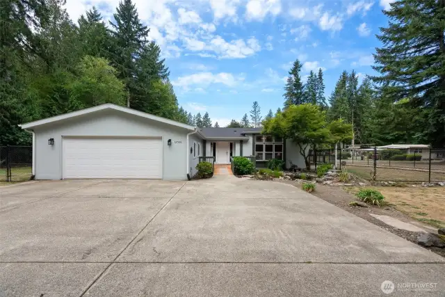 Welcome to your private retreat! Nestled among trees, this beautifully maintained single-story home sits on a spacious flat 1.34-acre lot. The wide driveway leads to an oversized 600+ sq. ft. attached garage, providing plenty of space for vehicles, storage, or hobbies.