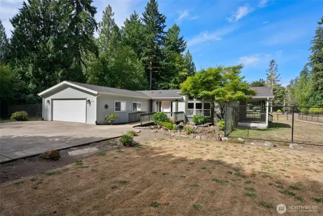 Spacious front yard and open lawn creates a peaceful, park-like setting. Plenty of paved parking and an oversized driveway provide convenience for guests, RVs, or extra vehicles.