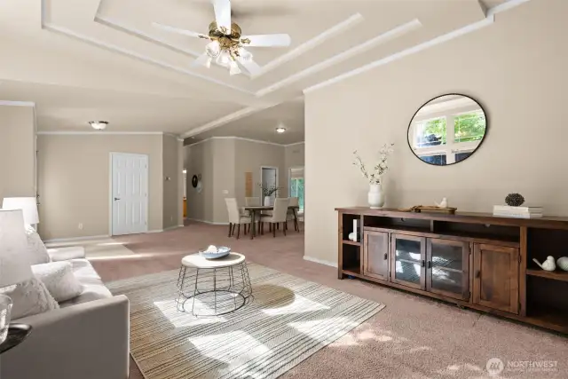 The neutral wall color create a warm, welcoming atmosphere, while the layout provides plenty of room for both formal seating and casual gatherings. It’s a versatile space perfect for entertaining or simply relaxing in comfort.