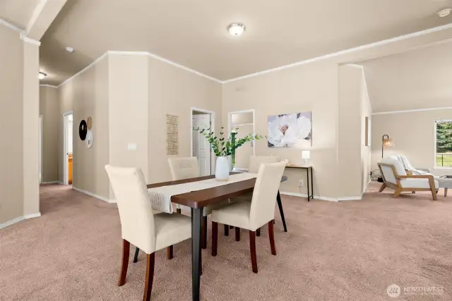 The dining area sits at the heart of the home. Its open design flows seamlessly into the living and sitting rooms, creating a natural gathering place.