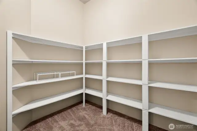 Spacious walk-in pantry is a dream for organized living—plenty of shelving to handle those big Costco runs, all your dry goods, and small kitchen appliances you don’t want cluttering the counters. A true storage bonus for everyday convenience and entertaining alike!
