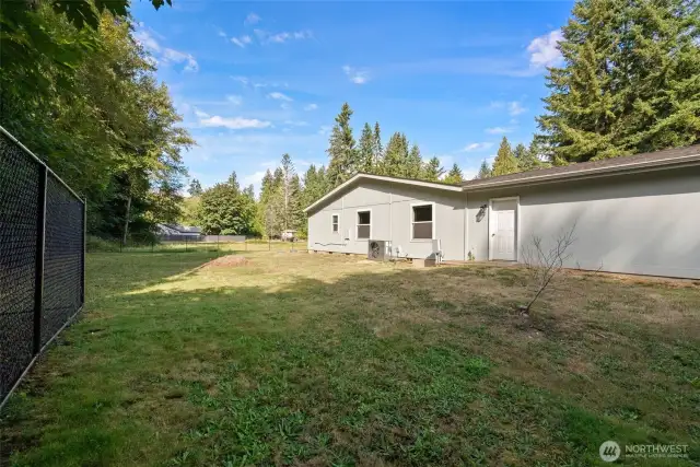 Spacious side yard with direct access to the garage, offering convenience and flexibility. Plenty of room to create a garden, play space, or additional outdoor entertaining area.