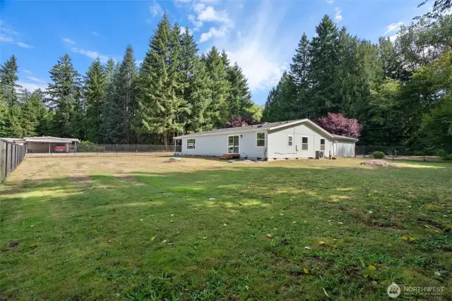 Another view of the fully fenced portion of the property, offering a secure and versatile outdoor space perfect for pets, play, gardening, or simply enjoying the peaceful setting.