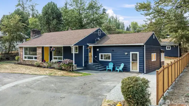 Convenient horseshoe driveway with easy in-and-out access, mature landscaping, and elevated curb presence.