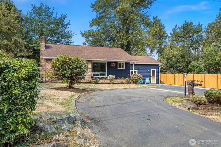 Horseshoe driveway offers ample off-street parking and frames the home’s inviting front elevation.