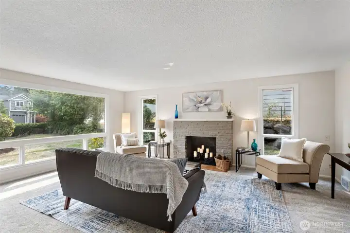 Oversized picture window anchors the room and brings in steady light from the front yard.