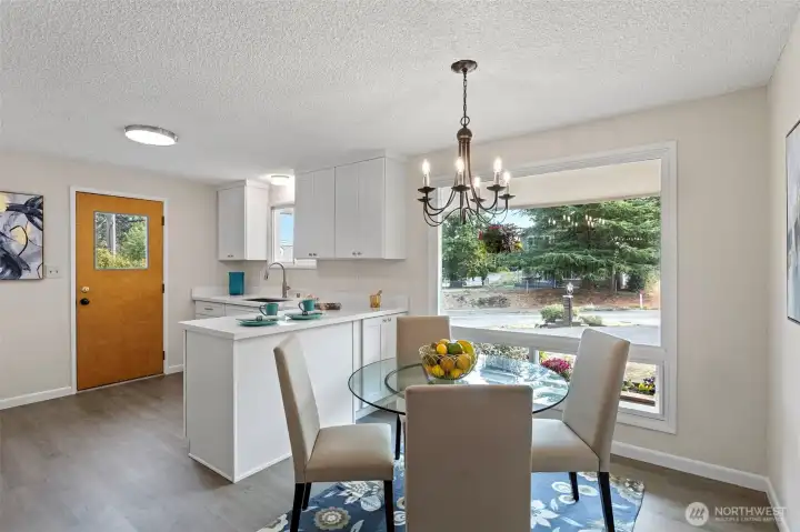 Bright and inviting, the dining area welcomes morning sun and frames the front yard through a wide east-facing window.