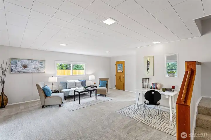 This lower flex room adds incredible versatility to the home—ideal for a second living area, media space, playroom, or creative studio. Thoughtfully set apart from the main living areas, it offers both quiet and connection. With fresh carpet underfoot, new lighting overhead, and access to the front driveway, this space adapts with ease.