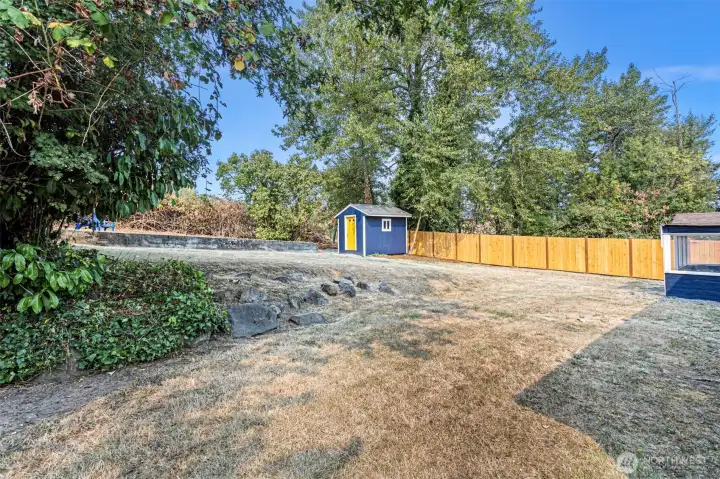 This terraced backyard combines privacy, function, and potential. A new fence spans the entire north lot line, while stonework, mature trees, and cleared upper grounds set the stage for gardening, play, or future projects. The freshly renovated shed adds charm and utility.