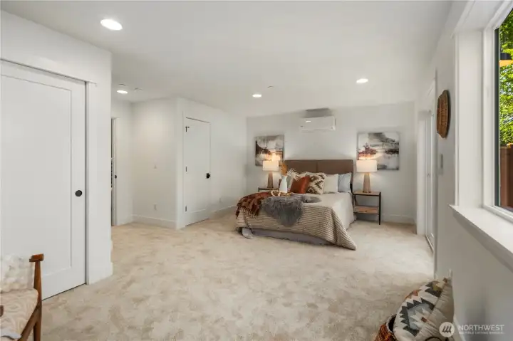 Lower Level Suite (Alternate View): Another angle of the spacious lower-level bedroom highlights the flexible layout, generous closet storage, and quiet privacy. Its scale and comfort make it ideal for extended stays or as a second primary suite option.  Staged photos are of the model home of the same floorplan within the Foxmoore community and are for visualization purposes only. Colors, finishes, and layout can and will vary.