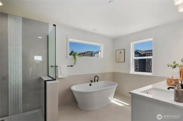 Primary Bathroom – Tub & Shower: Indulge in a freestanding soaking tub and a frameless glass shower accented with designer tile for a true spa-like experience. The thoughtful design balances elegance and relaxation with everyday practicality.  Staged photos are of the model home of the same floorplan within the Foxmoore community and are for visualization purposes only. Colors, finishes, and layout can and will vary.