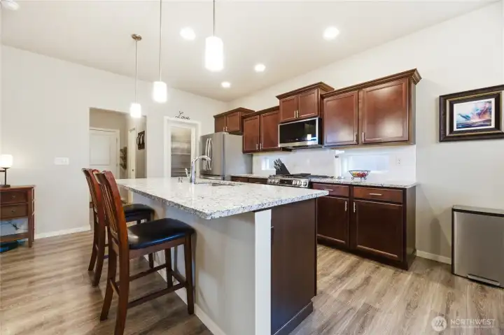 This gourmet kitchen with high end upgrades and rich cabinetry is a chef's dream