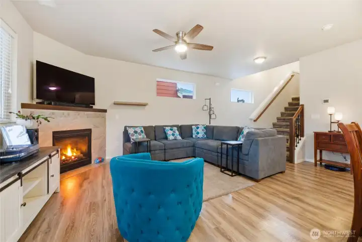 Kitchen looks out to living room with gas fireplace