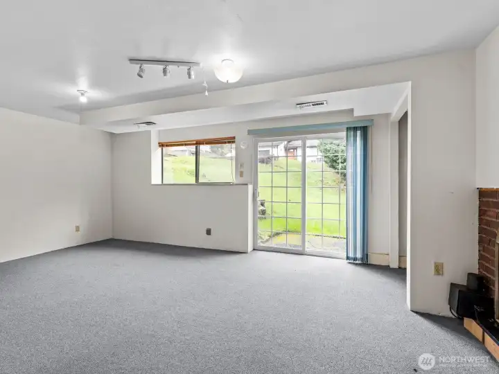 Straight ahead from the entry way is a spacious rec room featuring a wood burning fireplace with blower and access to the patio.