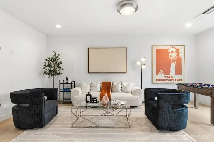 The lower level 4th bedroom suite or rec/media room as currently staged.