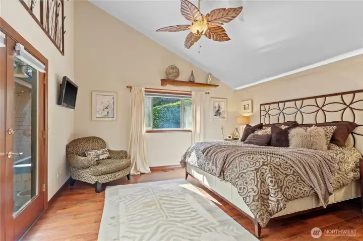 King size Primary bedroom with french doors leading out to covered deck & hottub