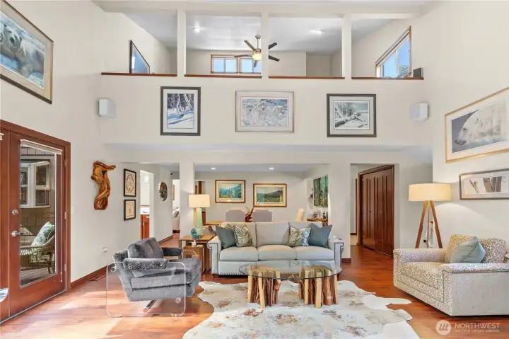 great room looking on to formal dining has french doors that lead to extensive decking