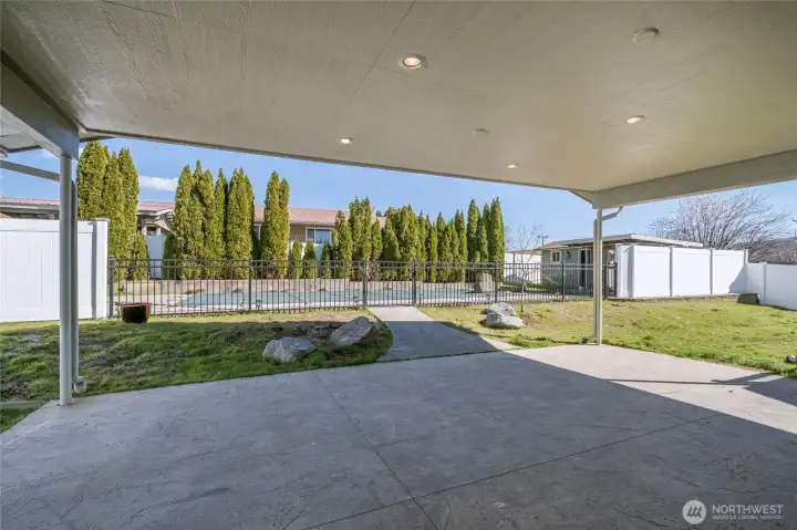 Cpvered patio and entrance to ool