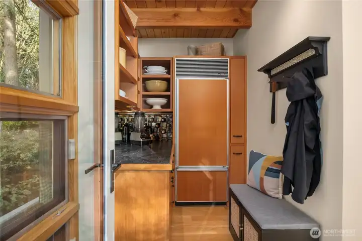 The back pantry with storage and fridge.