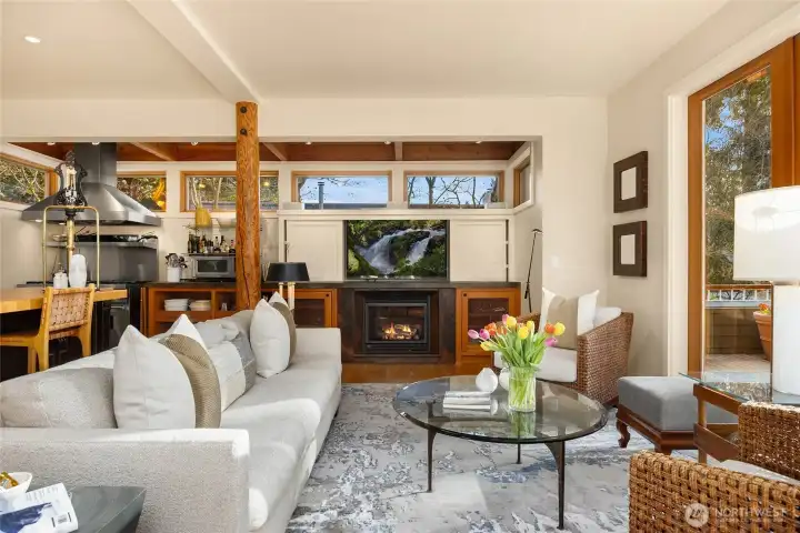 An intimate gathering living room with built in surround sound and TV.