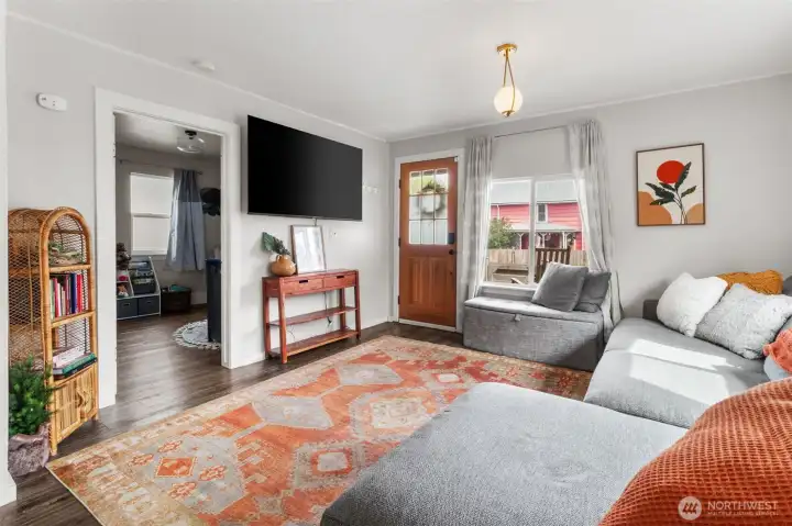 Living room with updated flooring and plenty of space for your furnishings