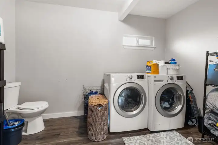 Well-placed laundry room with convenient half bath and potential for future expansion.