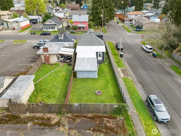 Aerial perspective highlights the home’s setting and fully fenced backyard.