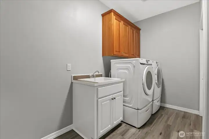 oversized laundry w/deep laundry tub and dedicated storage closet for cental vacuum, brooms, mops
