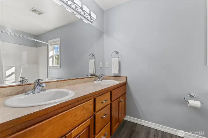 Hall bathroom with 2 sinks & dedicated linen closet